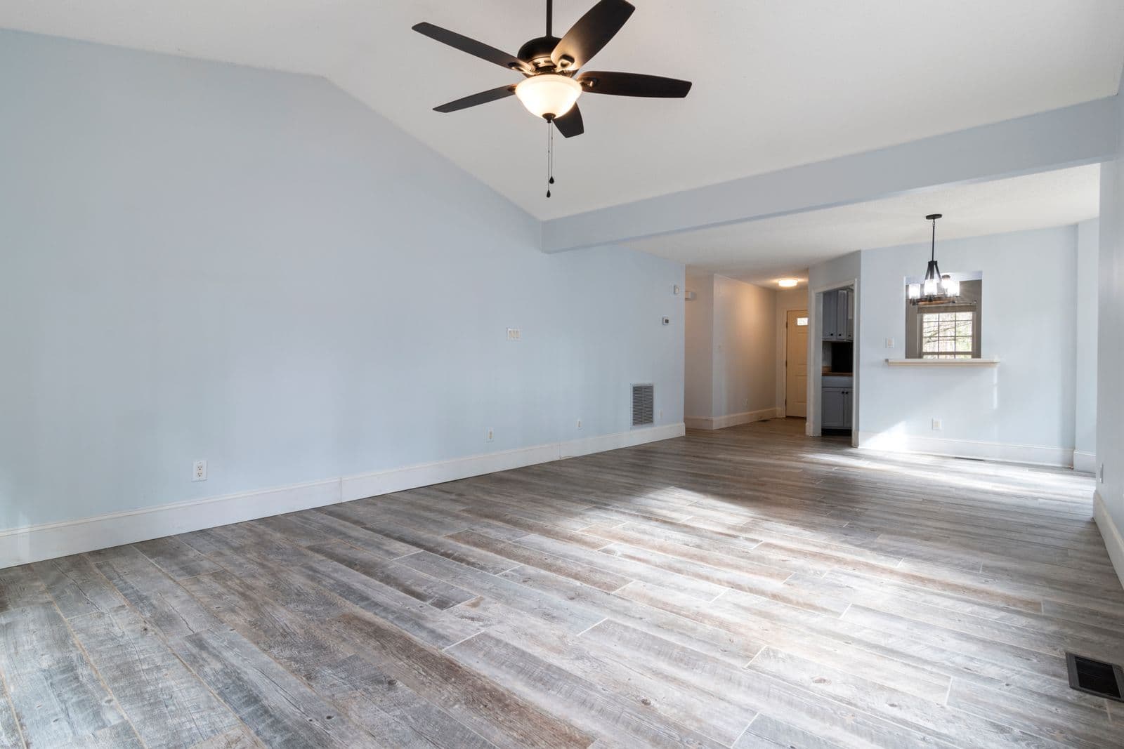 Before: the original photo used for the warm limewash walls and jute rug living room concept