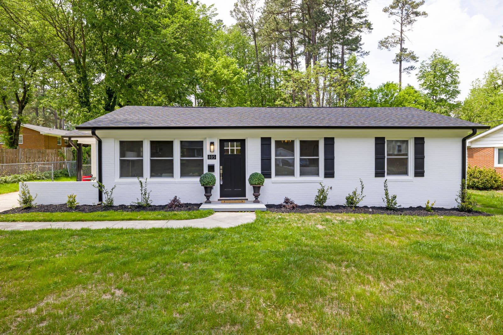 Before: the original photo used for the ranch home with uplighting and path lighting concept
